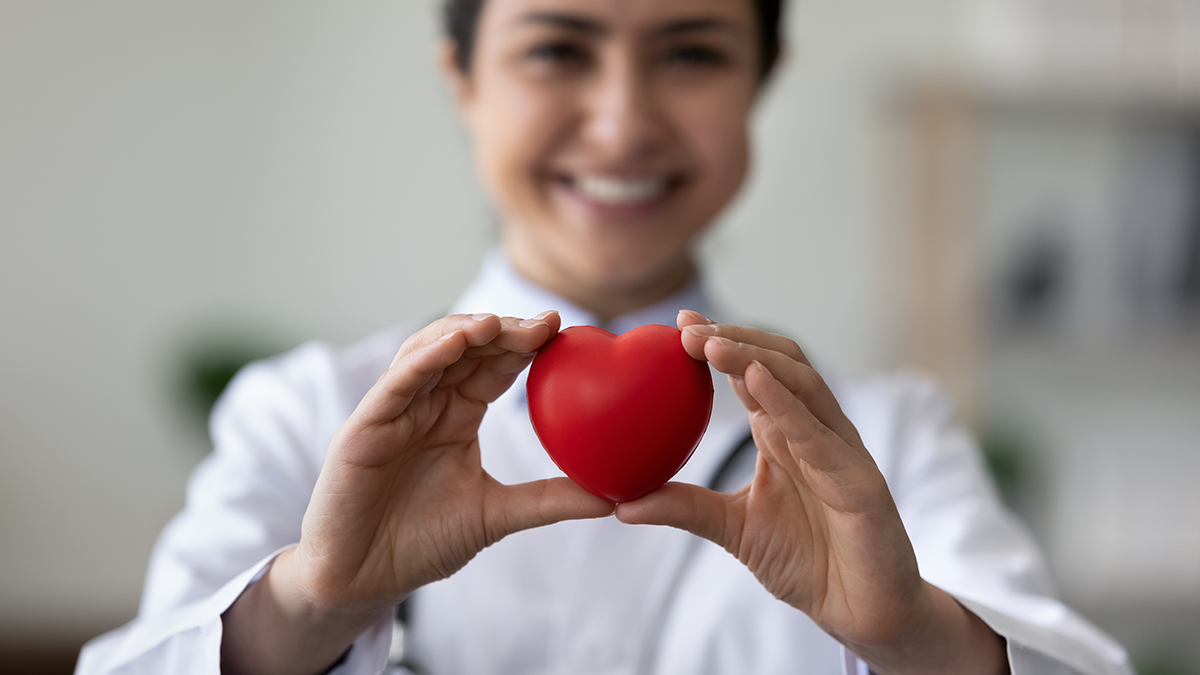 Lady smiling holding a love heart