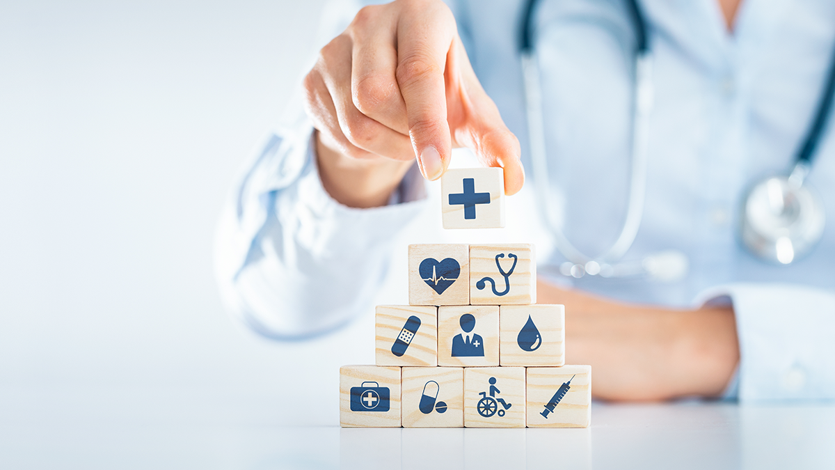 Man stacking health icon blocks