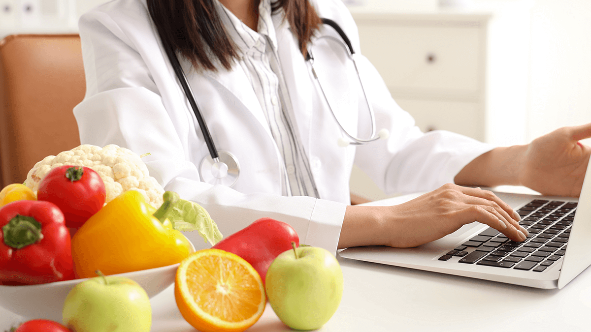 A female nutritionist typing on her laptop