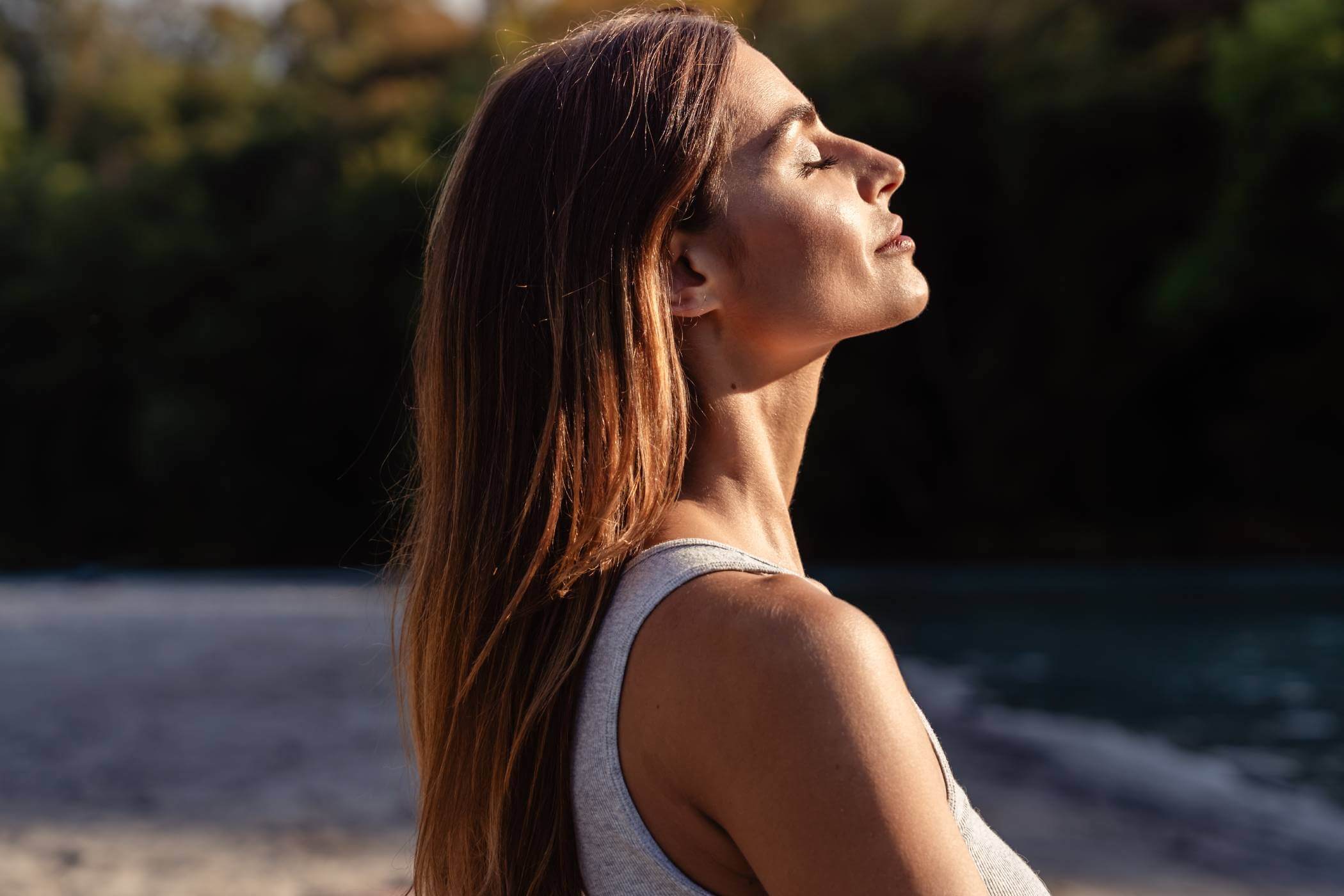 Woman smiling with sunlight directing her